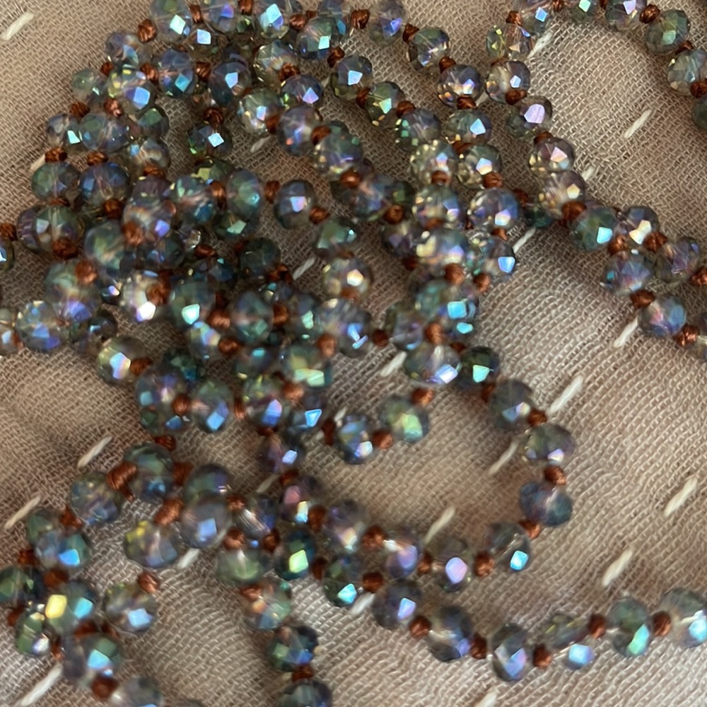 Clear hazy iridescent sparkly smaller beaded necklace. 60 inches